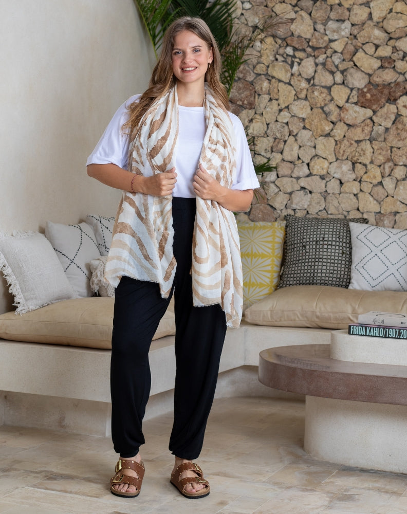 Woman wearing a patterned scarf in a living room setting
