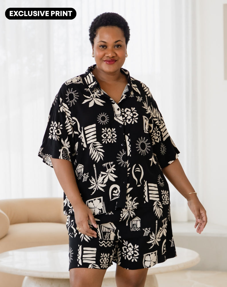 Woman wearing a black and white patterned outfit with 'Exclusive Print' text above.