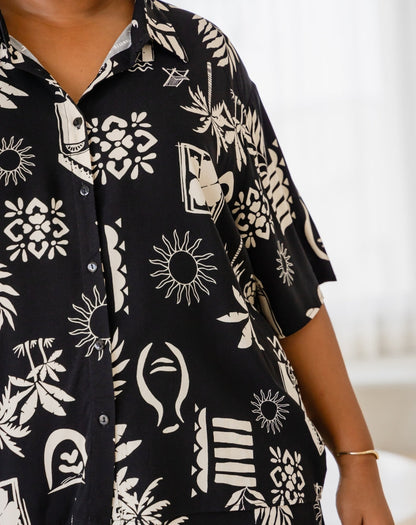 Black shirt with white abstract patterns worn by a person