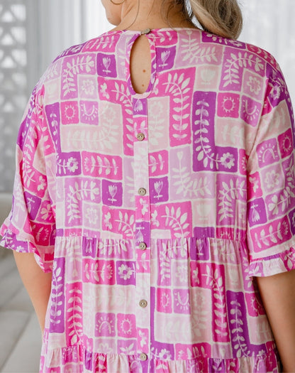 Pink and white patterned shirt worn by a person