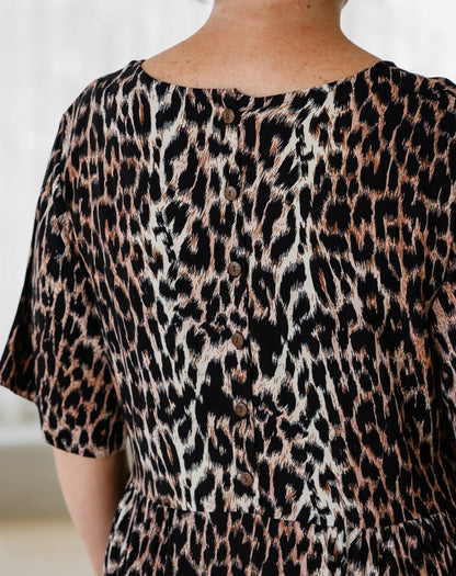 Leopard print top with buttons on a plain background