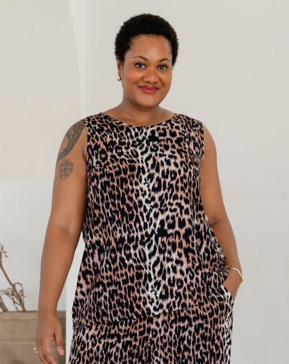 Woman wearing a leopard print dress against a plain background