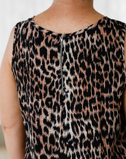 Leopard print sleeveless top worn by a person on a white background
